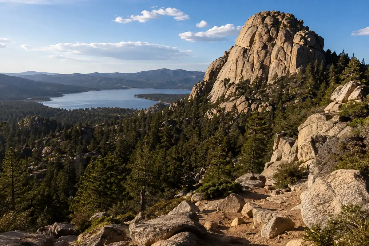 Large granite rock formation overlooking Big Bear Lake with pine trees in the foreground